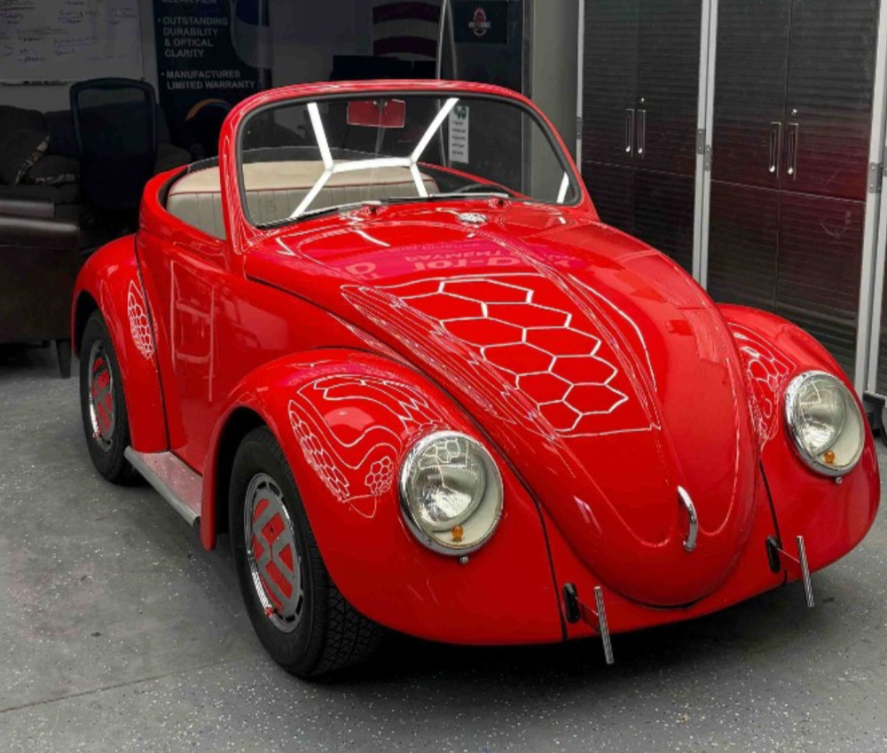 Custom red VW Beetle shorty convertible with shortened wheelbase and high-gloss finish.