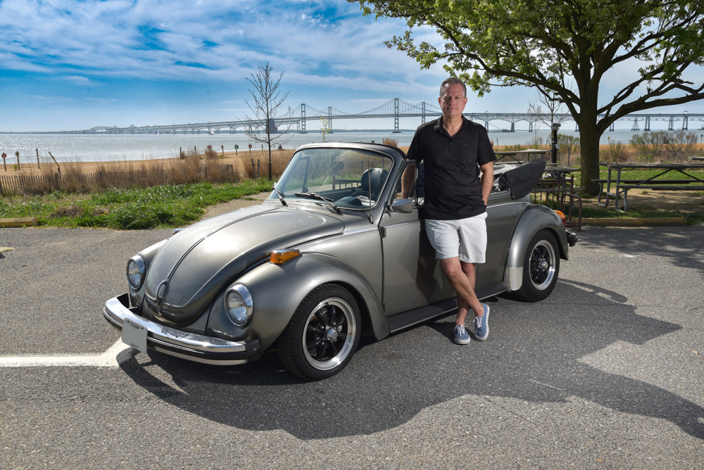 Dave Cook standing beside his 1979 Volkswagen Super Beetle convertible near the waterfront