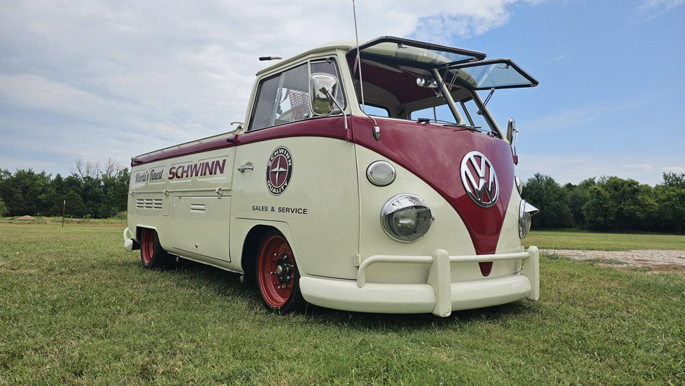 1967 VW Single Cab The Dude with Schwinn graphics parked on grass under a cloudy sky.