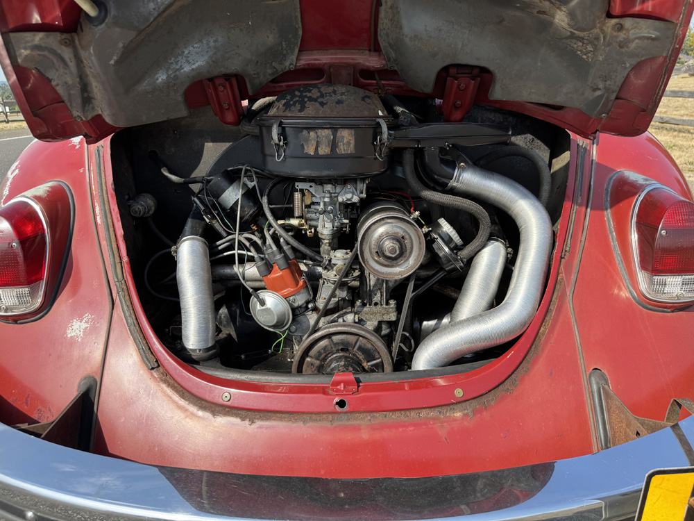 Rear engine compartment of red Beetle showing air cooled flat four layout