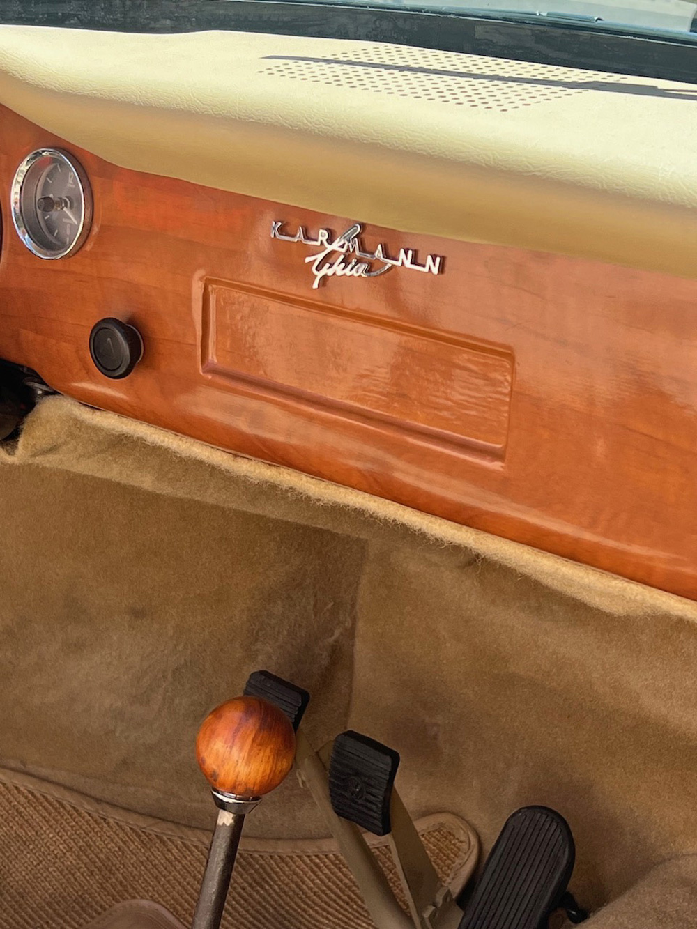 Interior of Danny Bonaduces Karmann Ghia showing the wood dash, tan carpet and vintage controls