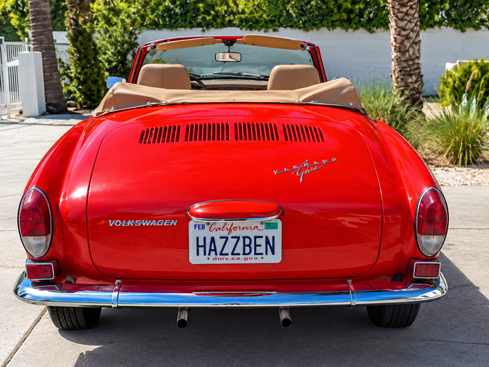 Rear view of Danny Bonaduces red Karmann Ghia convertible with the top down, parked in a sunny Palm Springs neighborhood