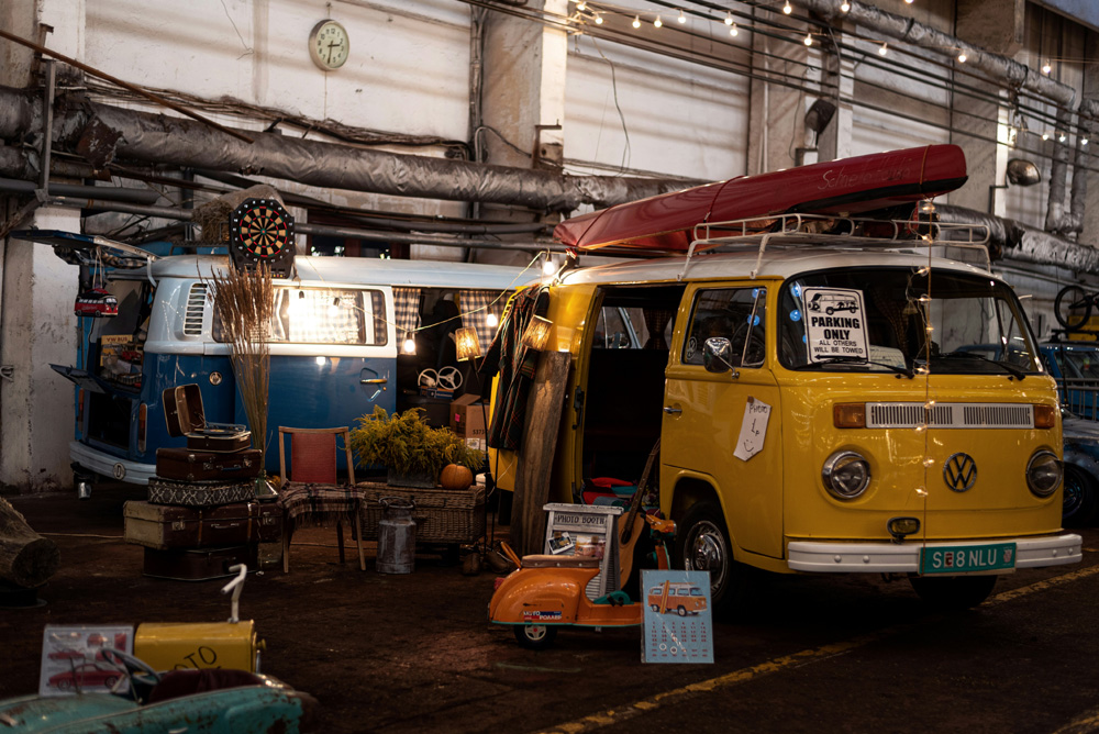 Vintage Volkswagen camper vans displayed indoors at a VW event