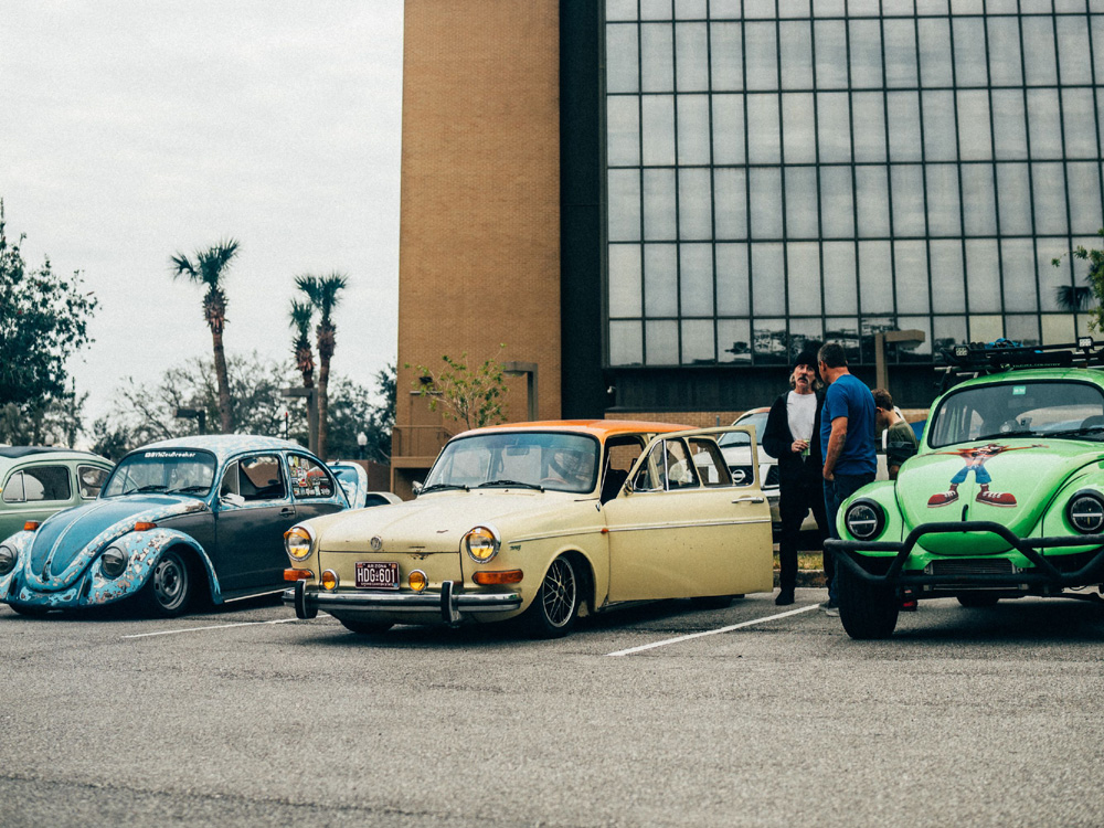 Blue Beetle, yellow Type 3 and green Beetle gathered in a parking lot show
