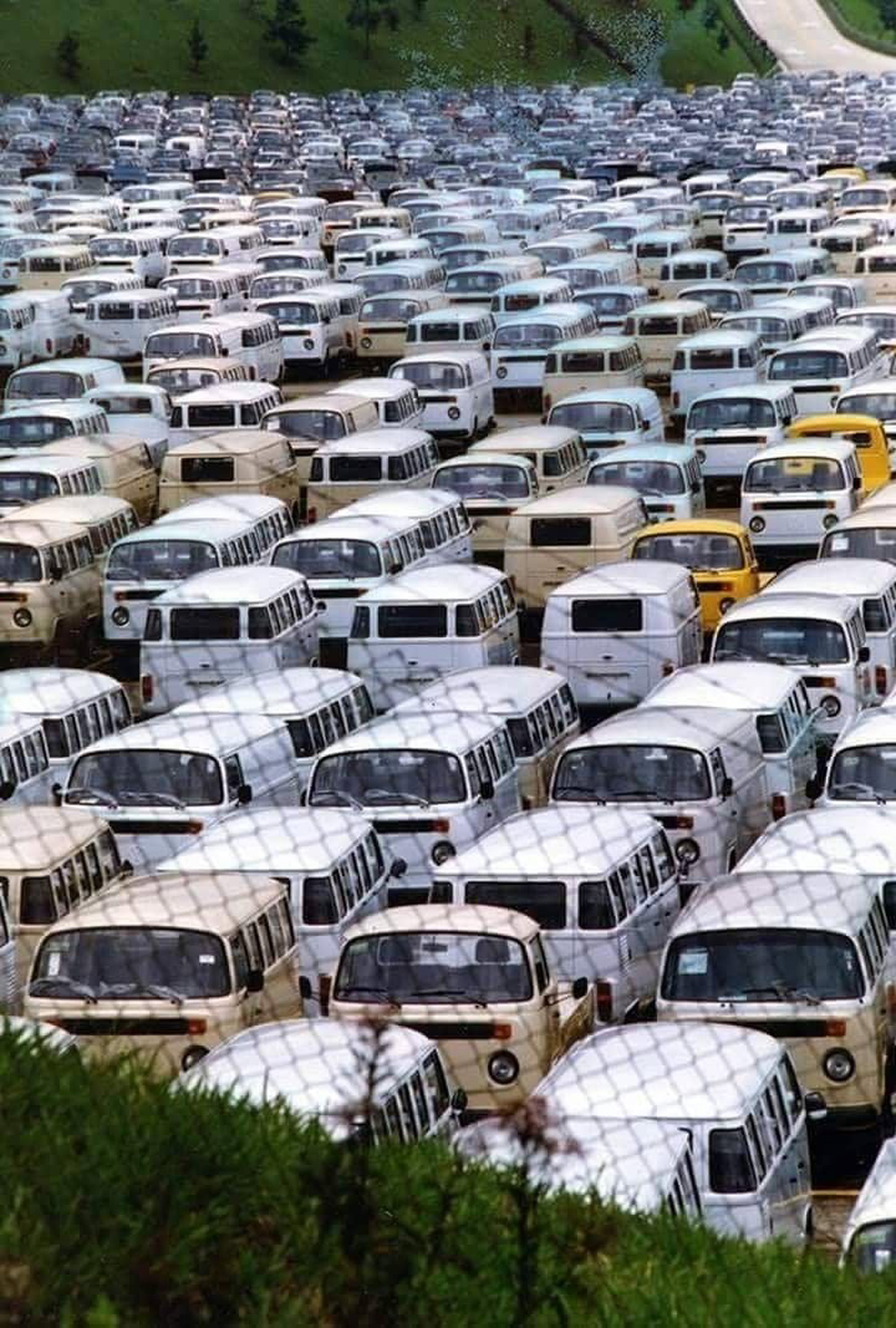 Large storage yard filled with rows of Brazilian built Volkswagen Kombis awaiting distribution