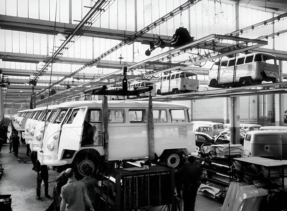 Vintage factory scene with workers assembling Volkswagen buses on the production line