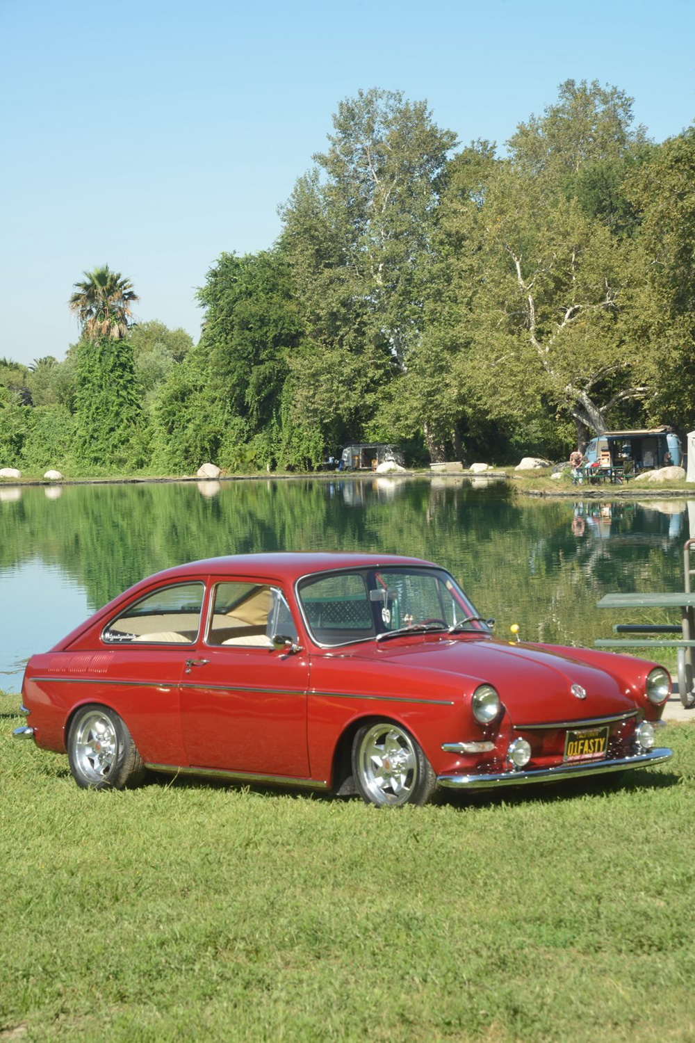 Red Volkswagen Type 3 Fastback parked by the lake during the El Prado VW Show & Shine