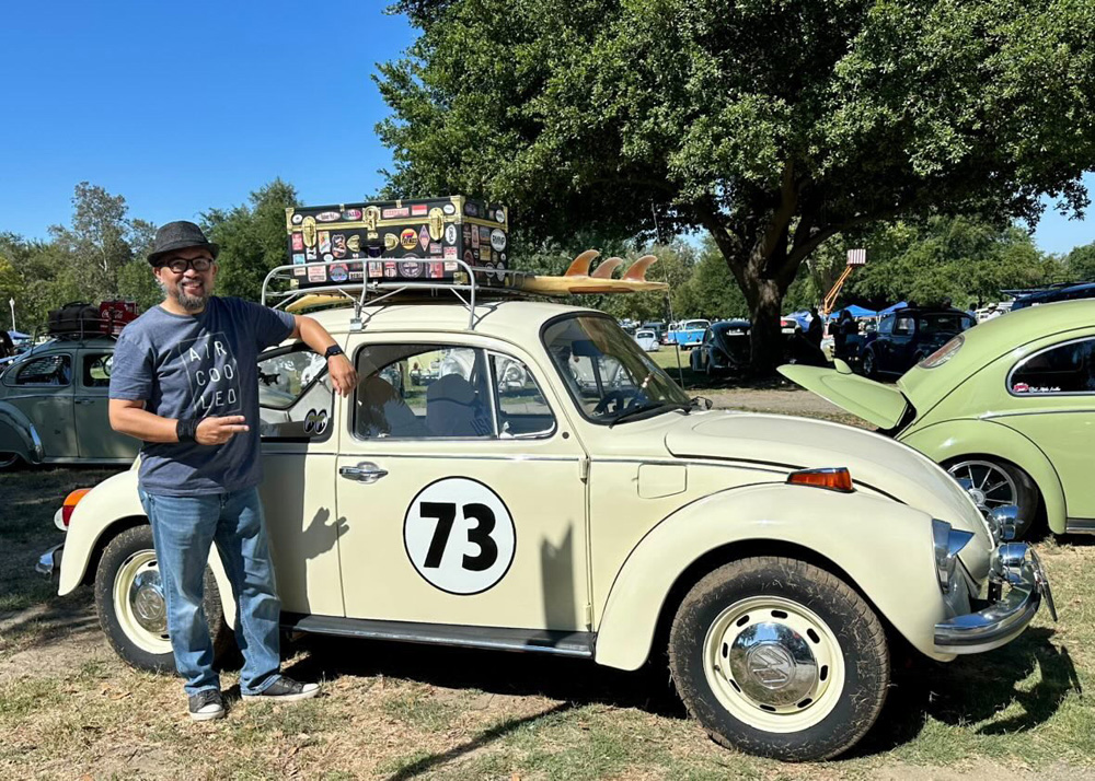 Sonny W posing with his cream Beetle numbered 73 at the El Prado VW Show & Shine