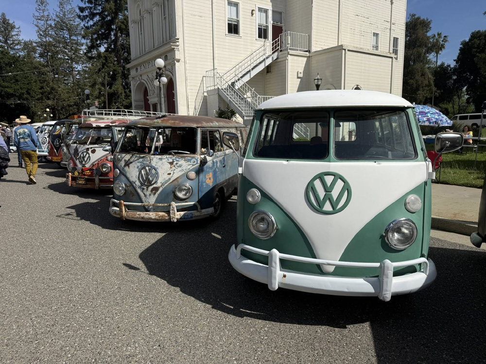 Vintage VW buses parked in front of the Empire building at the Kelley Park Spring Meet.