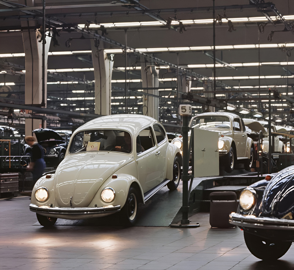 With the light of its headlamps reflected on the tiled floor of final assembly Hall 12