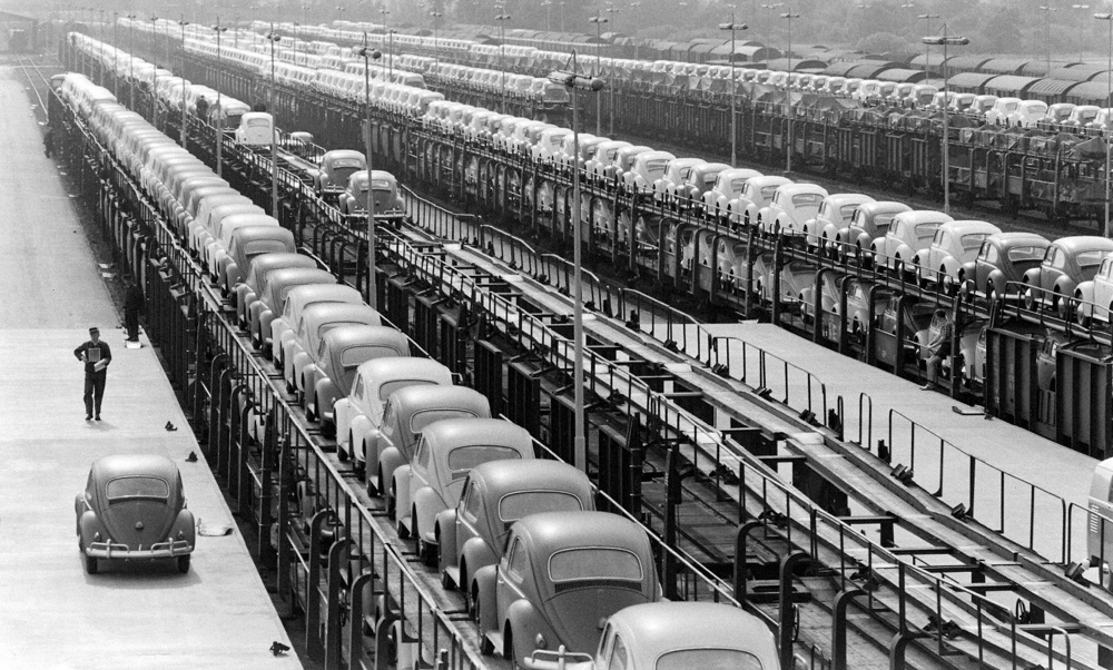 Several trains loaded with new Volkswagens await departure at the Verladebahnhof train loading depot on the north side of the Volkswagen factory in Wolfsburg in the late 1950s