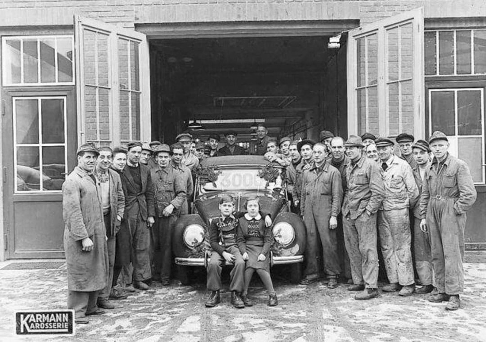 Proud Karmann workers are posing with the 3000th Volkswagen Kabriolett, in December 1950.