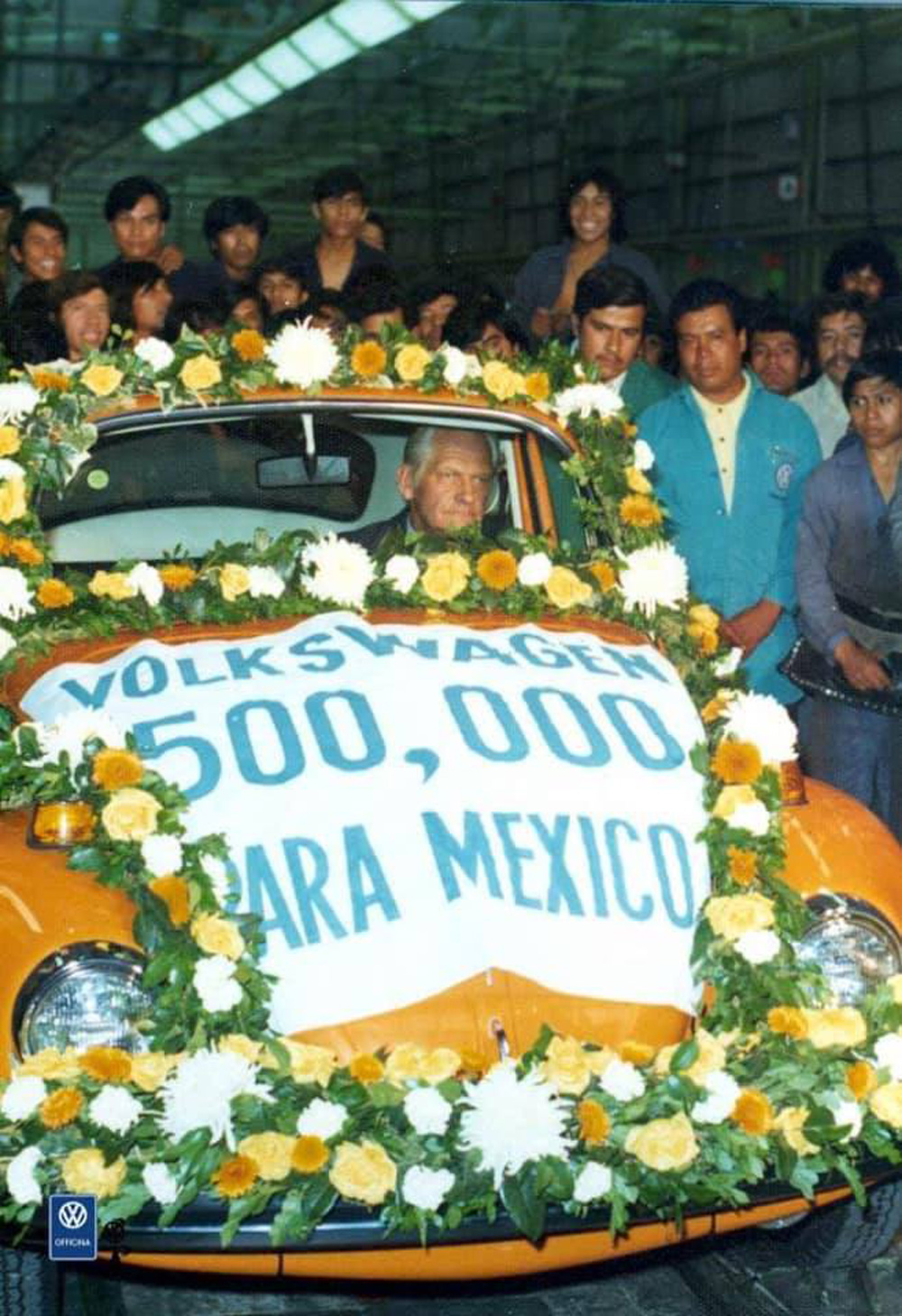 Volkswagens 500,000th Puebla-built Beetle driven by Hans Barschkis on the assembly line in 1975
