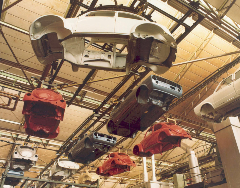 Mid-1970s Wolfsburg assembly line with painted Beetle bodies on overhead conveyor